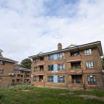Commercial black windows installed by First Windows full view of flats with grass