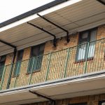 Cedar House Commercial black windows installed by First Windows close up of railing