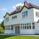 White uPVC windows and doors installed by First Windows with oak door