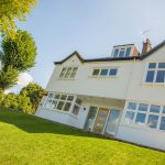 White uPVC windows and doors installed by First Windows outside view with grass