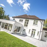 White uPVC windows and doors installed by First Windows with garden