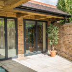 Patio doors installed on modern 3 story house close up shop - First Windows