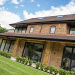 Patio sliding doors on modern 3 story house by First Windows