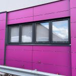Commercial black windows installed by First Windows with pink walls close up shot